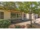Backyard with lush trees, desert landscaping, and a covered patio offers tranquil outdoor living at 3312 Lapwing Dr, North Las Vegas, NV 89084
