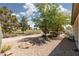 Backyard showcasing well-maintained landscaping, mature trees, and an open and green golf course view at 3312 Lapwing Dr, North Las Vegas, NV 89084