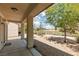 Spacious backyard with a covered patio and lush greenery, offering serene golf course views at 3312 Lapwing Dr, North Las Vegas, NV 89084