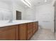 Large bathroom with double sinks and vanity with cabinets and drawers, a toilet, shower, and a large mirror at 3312 Lapwing Dr, North Las Vegas, NV 89084