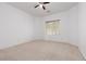 Cozy bedroom with neutral carpet, a window for natural light and a ceiling fan for comfort at 3312 Lapwing Dr, North Las Vegas, NV 89084