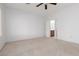 Comfortable bedroom with a window to let in natural light, a ceiling fan, and neutral carpet flooring at 3312 Lapwing Dr, North Las Vegas, NV 89084