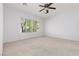 Inviting bedroom featuring a window with natural light, neutral carpet and a ceiling fan for added comfort at 3312 Lapwing Dr, North Las Vegas, NV 89084