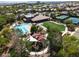 Aerial view of community pool, clubhouse, playground, and tennis courts surrounded by lush landscaping at 3312 Lapwing Dr, North Las Vegas, NV 89084