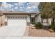Charming single-story home featuring a well-maintained front yard and a two-car garage at 3312 Lapwing Dr, North Las Vegas, NV 89084