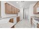 Modern kitchen with white appliances, wood cabinets, and tile flooring, perfect for cooking and entertaining guests at 3312 Lapwing Dr, North Las Vegas, NV 89084