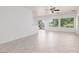 Open living area featuring tile floors, sliding glass doors to the outdoors, and ample natural light at 3312 Lapwing Dr, North Las Vegas, NV 89084