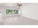 Bright living space with tile flooring, multiple windows, and view of the outdoor landscape at 3312 Lapwing Dr, North Las Vegas, NV 89084