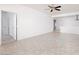 Open living room with tile flooring, a ceiling fan, and doorways leading to other rooms at 3312 Lapwing Dr, North Las Vegas, NV 89084