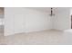 Spacious living room with neutral flooring, ample natural light, and a modern chandelier at 3312 Lapwing Dr, North Las Vegas, NV 89084