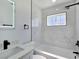 Modern bathroom features a stylish vanity, a large mirror, and a shower with marble tile at 3326 Mount Charleston Dr, Pahrump, NV 89048