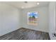 A bright bedroom with wood floors and a large window overlooking the desert landscape at 3326 Mount Charleston Dr, Pahrump, NV 89048