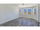 Bright bedroom with hardwood floors and three windows overlooking desert landscape at 3326 Mount Charleston Dr, Pahrump, NV 89048