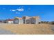 Lovely home features neutral stucco, an orange tile roof, a concrete driveway, and desert landscaping at 3326 Mount Charleston Dr, Pahrump, NV 89048