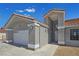 Attractive home featuring neutral colors, an orange tile roof, and a spacious concrete driveway at 3326 Mount Charleston Dr, Pahrump, NV 89048