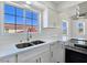Bright kitchen featuring stainless steel appliances, white cabinets, and quartz countertops at 3326 Mount Charleston Dr, Pahrump, NV 89048