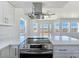 Bright kitchen featuring stainless steel appliances, white cabinets, quartz countertops, and ventilation hood at 3326 Mount Charleston Dr, Pahrump, NV 89048