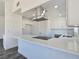 Bright kitchen with white cabinetry, quartz countertops, stainless steel appliances and hardwood flooring at 3326 Mount Charleston Dr, Pahrump, NV 89048