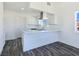 Bright kitchen with white cabinetry, quartz countertops, stainless steel appliances and hardwood flooring at 3326 Mount Charleston Dr, Pahrump, NV 89048
