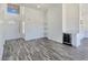 Bright and airy living room with gray wood-look floors, wine fridge, and high ceilings at 3326 Mount Charleston Dr, Pahrump, NV 89048