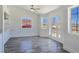 Inviting open-concept area with gray floors, a ceiling fan and lots of natural light at 3326 Mount Charleston Dr, Pahrump, NV 89048
