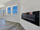 Modern living space featuring gray floors, white walls, and an electric fireplace at 3326 Mount Charleston Dr, Pahrump, NV 89048