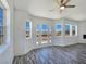 Bright living room with hardwood floors, base trim, large windows, and sliding doors to the backyard at 3326 Mount Charleston Dr, Pahrump, NV 89048