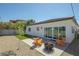 Cozy backyard features a fire pit, rocking chairs, and artificial grass at 3440 Ernest St, North Las Vegas, NV 89032