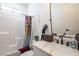 Bright bathroom featuring a shower-tub combo and a white vanity at 3440 Ernest St, North Las Vegas, NV 89032