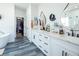 Bright bathroom with double vanity, modern fixtures, tub, and walk-in closet at 3440 Ernest St, North Las Vegas, NV 89032