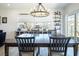Well-lit dining room featuring a large table and display shelves at 3440 Ernest St, North Las Vegas, NV 89032