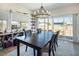 Bright dining room featuring a modern light fixture and sliding glass doors to the backyard at 3440 Ernest St, North Las Vegas, NV 89032