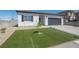 Inviting single-story home showcasing desert landscaping and a well-maintained lawn at 3440 Ernest St, North Las Vegas, NV 89032
