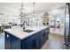 Spacious kitchen with a central island, modern lighting, and stainless steel appliances at 3440 Ernest St, North Las Vegas, NV 89032