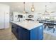 Open-concept kitchen featuring a large island, modern lighting, and sleek countertops at 3440 Ernest St, North Las Vegas, NV 89032