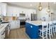 Bright kitchen with a center island, stainless steel appliances, and modern white cabinetry at 3440 Ernest St, North Las Vegas, NV 89032