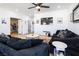 Comfortable living room with plank floors, dark couches, and a media center at 3440 Ernest St, North Las Vegas, NV 89032