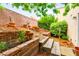 Landscaped backyard features brick-lined planters and mature foliage at 3619 Hat Rock Ct, Las Vegas, NV 89129