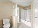 Bright bathroom features a shower-tub combo with sliding glass doors, plus toilet at 3619 Hat Rock Ct, Las Vegas, NV 89129
