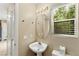 Powder room featuring a pedestal sink, decorative lighting, and a window with natural light at 3619 Hat Rock Ct, Las Vegas, NV 89129