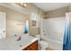 Bathroom featuring a shower-tub combo, wooden sink, and a mounted mirror at 3619 Hat Rock Ct, Las Vegas, NV 89129