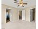Carpeted bedroom features three access doors, plus a ceiling fan at 3619 Hat Rock Ct, Las Vegas, NV 89129