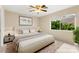 Comfortable bedroom with natural light, neutral tones, and a ceiling fan at 3619 Hat Rock Ct, Las Vegas, NV 89129