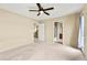 Large, carpeted bedroom with ceiling fan, access to balcony, and an ensuite bath at 3619 Hat Rock Ct, Las Vegas, NV 89129