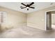 Bedroom with carpet, ceiling fan, one window and a door leading to the hallway at 3619 Hat Rock Ct, Las Vegas, NV 89129