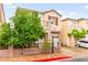 Two-story home with neutral exterior and mature trees in front at 3619 Hat Rock Ct, Las Vegas, NV 89129
