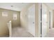 Upstairs hallway with neutral carpeting, doors, and windows providing natural light at 3619 Hat Rock Ct, Las Vegas, NV 89129