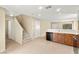 Open-concept kitchen with a staircase leading to the upper level, featuring tile flooring at 3619 Hat Rock Ct, Las Vegas, NV 89129