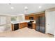 Open kitchen with stainless appliances, tile floor, and ample cabinet space overlooking the living area at 3619 Hat Rock Ct, Las Vegas, NV 89129