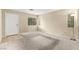 A well-lit living room with neutral carpet and walls and a large window at 3619 Hat Rock Ct, Las Vegas, NV 89129